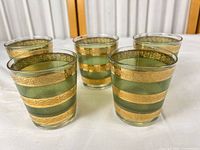 Five green and gold striped rocks glasses