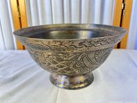 Side view showing full bowl profile and engraved dragon pattern