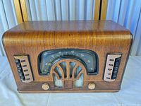 Front view of Zenith wooden tabletop radio showing dial, grille, knobs