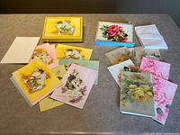 Complete lot showing both boxed sets, cards spread out, and envelopes