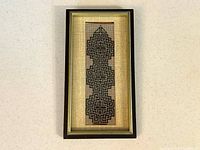 Front view of framed petit point textile art showing Celtic knot design