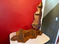 Both corner shelves, one standing, one laid horizontally showing tier design