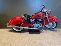 full left side view of red Indian Chief model on stand