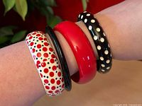 all four bangles stacked on wrist showing colors and patterns