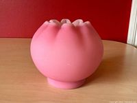 Side profile showing bulbous ribbed body and matte pink finish