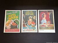 Front view of all three poster prints in sleeves