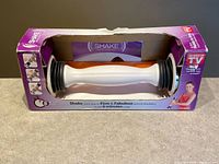 Shake Weight device inside original purple retail box front view