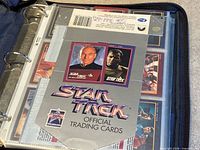 Binder open displaying Star Trek Official Trading Cards title sheet inside sleeves