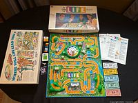 Overall view showing box, open board with spinner, components, instructions