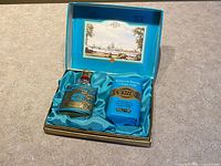 Open gift box showing eau de cologne bottle and soap bar nestled in satin lining