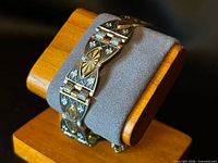 Bracelet displayed on stand showing front link design and clasp