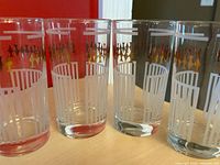 Front view of four tumblers showing white pinstripes and gold geometric band