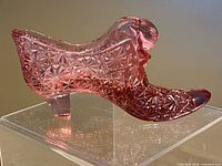 Right side view of cranberry pink cat-head slipper showing Daisy and Button pattern