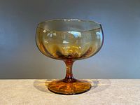Full view of amber glass pedestal bowl showing shape, color, and pedestal base