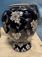 Front view of cobalt blue vase with white floral design