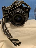 Front view showing Canon EOS 650 with attached EF 35-70mm lens and neck strap