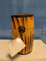 closed wooden barrel case with tag