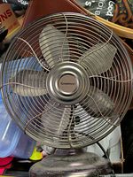 Full view of Garrison metal desk fan showing cage, blades and base