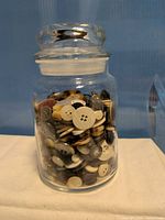 full view of lidded jar filled with buttons