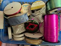 Basket showing multiple ribbon spools of various types and colors