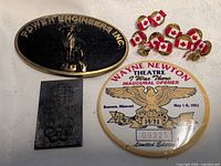 Group shot showing belt buckle, CBC pin, Wayne Newton button and Canadian flag pins