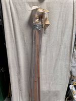 Bundle of six wood flagpoles wrapped in plastic