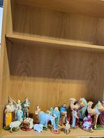 Full group of ceramic nativity figures on shelf
