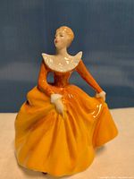 Front view of Royal Doulton figurine showing dress and collar