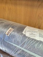 KindBed label on plastic-wrapped bolster cushion