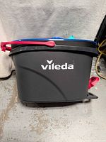 Side view of grey Vileda bucket showing logo