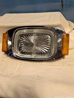 Top view of chrome dish showing bakelite handles and glass insert