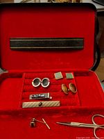 open jewelry case showing all accessories in red velvet interior
