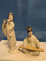 Both porcelain figurines side by side