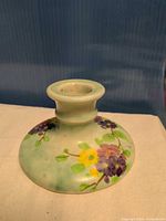 Front view of ceramic candlestick showing floral decoration