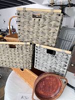 All seven pieces grouped: three grey baskets, chevron hamper, wicker basket, wooden tray