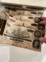 Stack of $20 Confederate notes showing front vignettes and serials