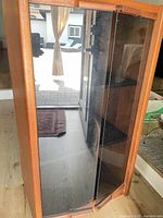 Front view showing smoked glass double doors and wood frame