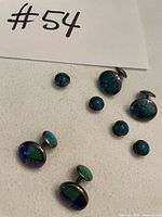 Full set showing cufflinks and shirt studs on white background