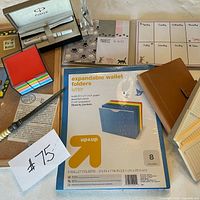 Overview showing Parker pen case, sticky notes, letter opener, expandable folders, notepads and notebook