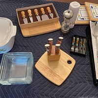 Group shot of all serveware items including casserole, pepper mill, glass bowls, cheese knives, spreaders, beaded servers, platter