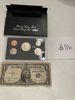 Full lot: proof set in holder with outer sleeve and $1 silver certificate front