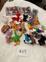 Overview of all Teenie Beanie Babies laid on white surface