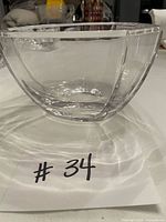 Side view of clear crystal bowl showing faceted panels