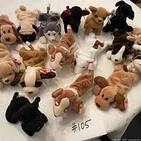 Overall shot showing 17 Ty Beanie Baby dogs with tags