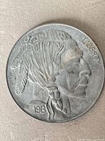 Obverse view showing full Native American profile and 1913 date on cast metal token