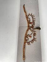 Full view of necklace laid out to show overall length and bead fringe