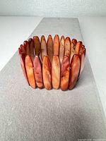 Side view of entire stretch stone bracelet showing bead color and arrangement