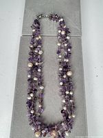 Full view of necklace laid flat showing multi-strand construction and clasp