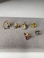 All six angel and cherub pins displayed