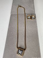 Set showing necklace and matching earrings laid out